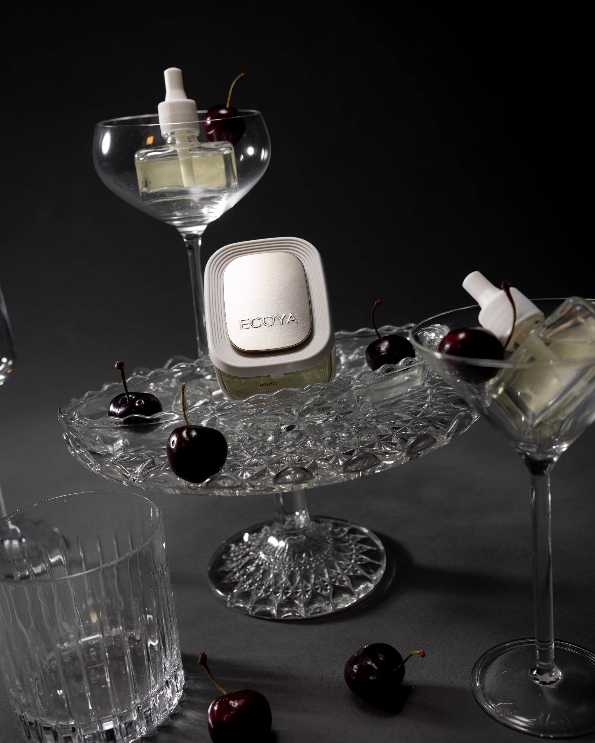 Ecoya plugin on a glass stand with cherries and a dark background