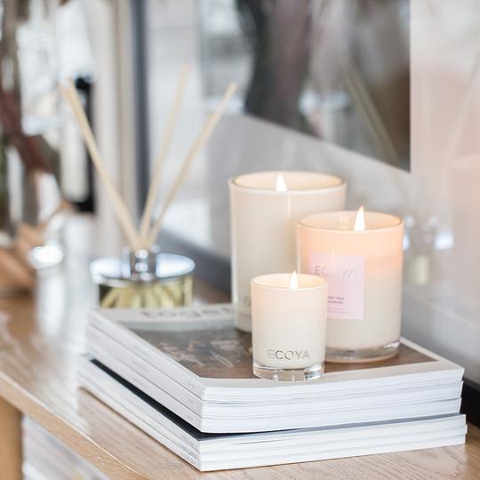 ECOYA Vanilla Bean Candle on books